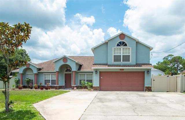 6420 Addax Ave, Cocoa, FL 32927 - traditional-style house featuring stucco siding, stone siding, a garage, driveway, and a gate