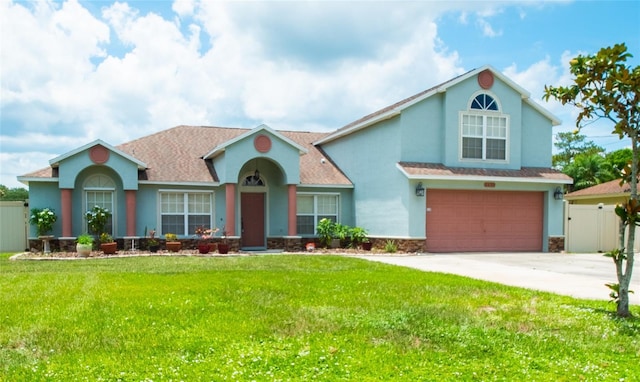 6420 Addax Ave, Cocoa, FL 32927 - view of front facade with stucco siding, a garage, driveway, and stone siding