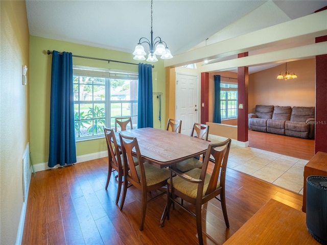 6420 Addax Ave, Cocoa, FL 32927 - dining room featuring a chandelier, lofted ceiling, and light wood-type flooring