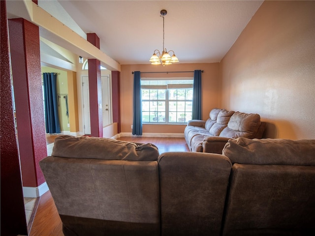 6420 Addax Ave, Cocoa, FL 32927 - living area featuring a chandelier, light wood-style floors, and vaulted ceiling