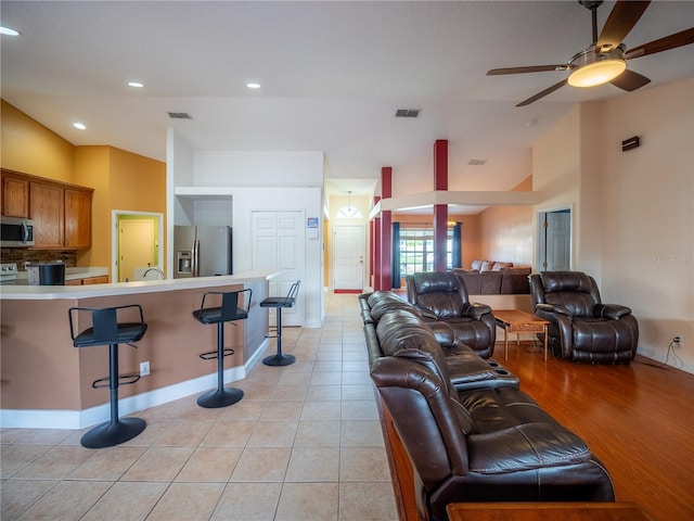6420 Addax Ave, Cocoa, FL 32927 - living room featuring ceiling fan, light tile patterned floors, recessed lighting, and vaulted ceiling