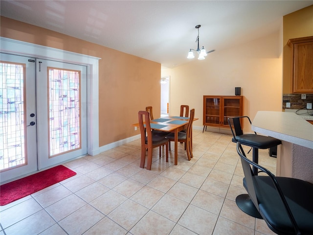 6420 Addax Ave, Cocoa, FL 32927 - dining area featuring french doors, light tile patterned flooring, lofted ceiling, and a chandelier