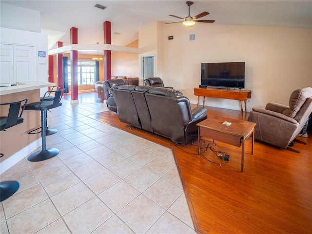 6420 Addax Ave, Cocoa, FL 32927 - living area with lofted ceiling, ceiling fan, light tile patterned floors, and a chandelier