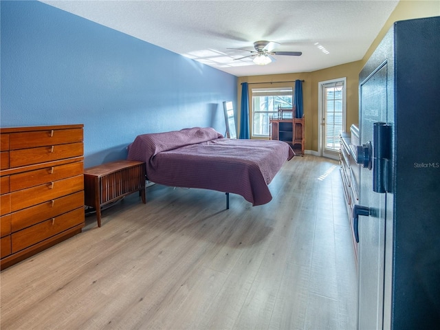 6420 Addax Ave, Cocoa, FL 32927 - bedroom with light wood-type flooring, ceiling fan, and a textured ceiling