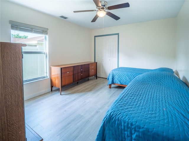 6420 Addax Ave, Cocoa, FL 32927 - bedroom with light wood-style floors, a closet, and ceiling fan
