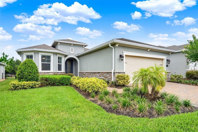 470 Briarbrook Way, Deland, FL 32724 - view of front of property featuring stone siding, stucco siding, a garage, and decorative driveway