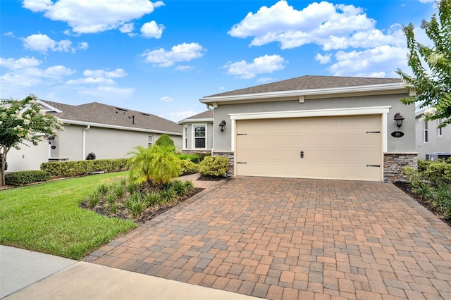 470 Briarbrook Way, Deland, FL 32724 - view of front facade featuring decorative driveway, stone siding, stucco siding, a front lawn, and an attached garage