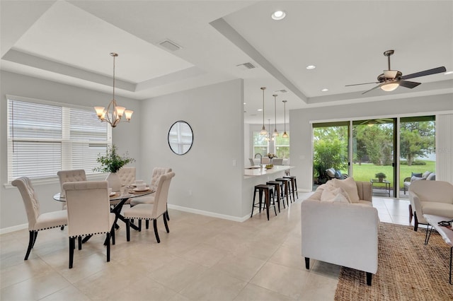 470 Briarbrook Way, Deland, FL 32724 - dining space featuring a tray ceiling, a chandelier, light tile patterned flooring, a ceiling fan, and recessed lighting