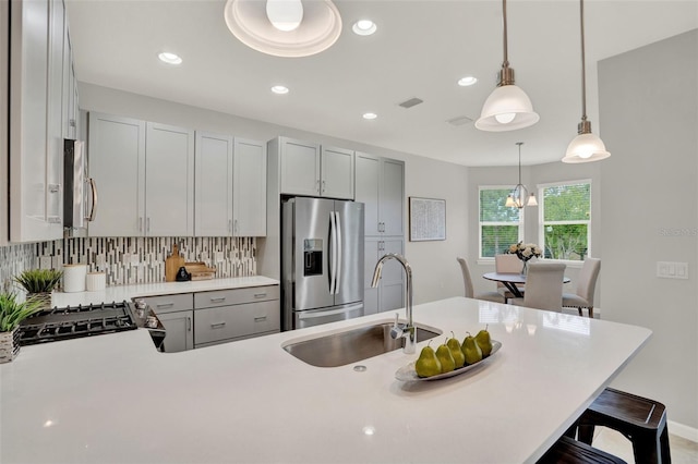 470 Briarbrook Way, Deland, FL 32724 - kitchen featuring stainless steel fridge, light countertops, a kitchen bar, decorative light fixtures, and decorative backsplash