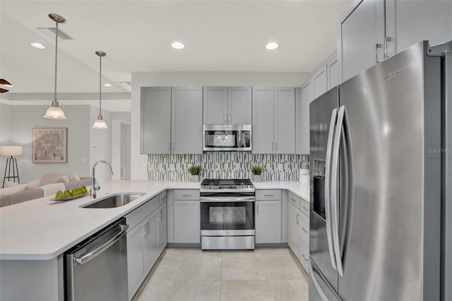 470 Briarbrook Way, Deland, FL 32724 - kitchen with stainless steel appliances, gray cabinetry, tasteful backsplash, light tile patterned floors, and a peninsula