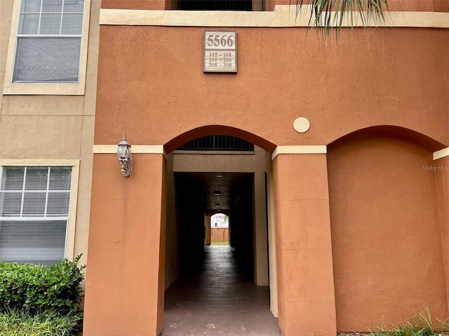 5566 Metrowest Blvd Unit 2-105, Orlando, FL 32811 - view of exterior entry with stucco siding