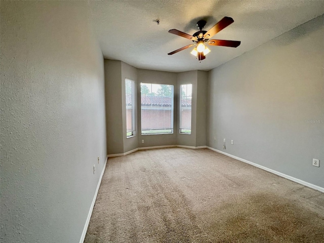 5566 Metrowest Blvd Unit 2-105, Orlando, FL 32811 - spare room with ceiling fan, carpet, a textured ceiling, a textured wall, and fire sprinkler in ceiling