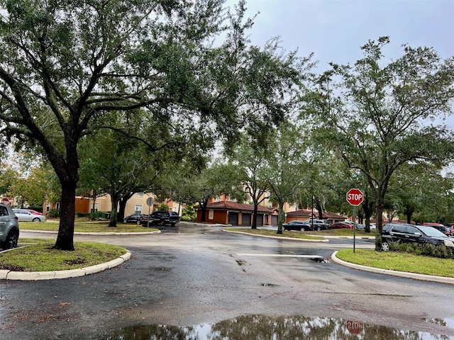 5566 Metrowest Blvd Unit 2-105, Orlando, FL 32811 - view of asphalt street featuring traffic signs and curbs