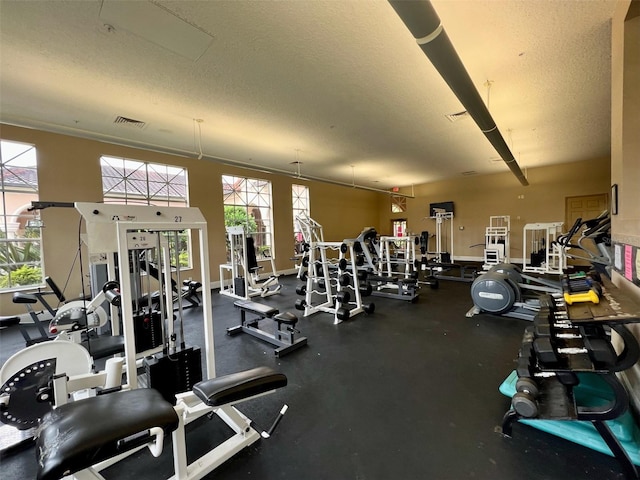 5566 Metrowest Blvd Unit 2-105, Orlando, FL 32811 - exercise room with a textured ceiling