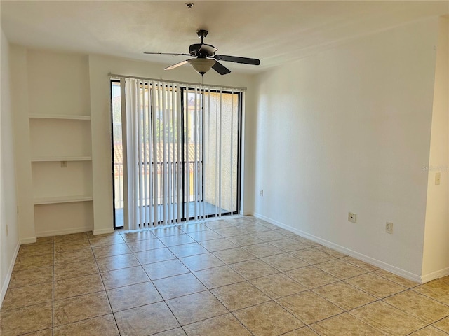 6153 Metrowest Blvd Unit 205, Orlando, FL 32835 - unfurnished room featuring ceiling fan, built in shelves, and light tile patterned flooring