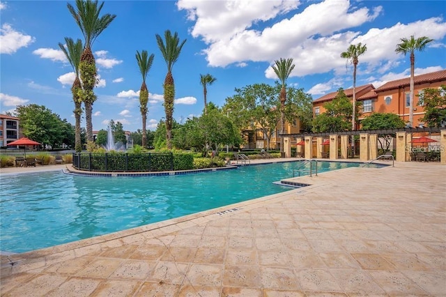 6153 Metrowest Blvd Unit 205, Orlando, FL 32835 - community pool featuring a patio