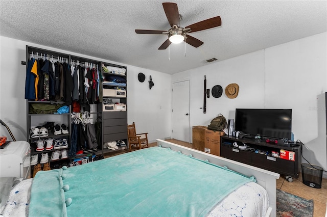 2666 Capp Cir, Kissimmee, FL 34744 - bedroom with a textured ceiling and ceiling fan