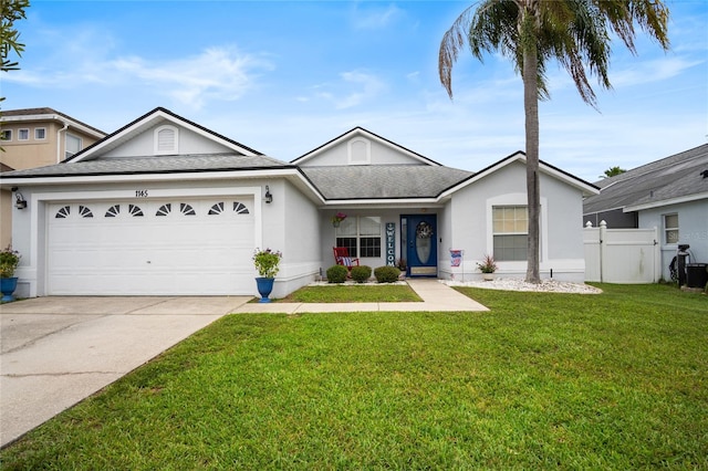 1145 Jaybee Ave, Davenport, FL 33897 - ranch-style home with driveway, an attached garage, stucco siding, and roof with shingles