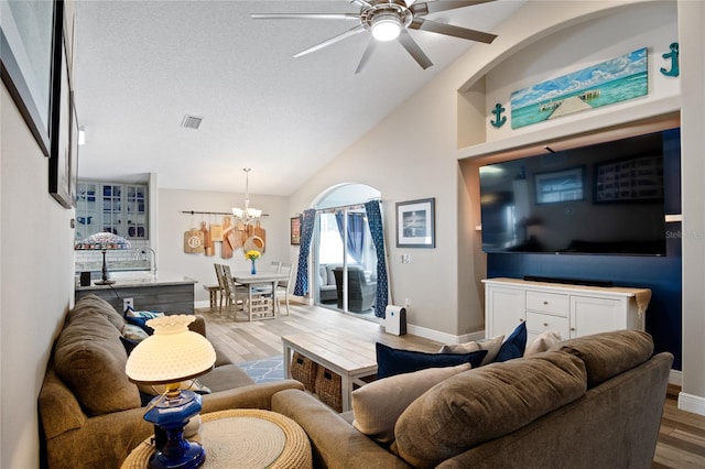 1145 Jaybee Ave, Davenport, FL 33897 - living room with wood finished floors, ceiling fan, a chandelier, and lofted ceiling