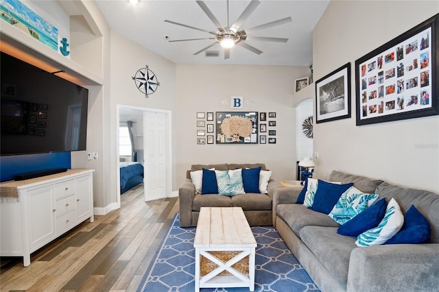 1145 Jaybee Ave, Davenport, FL 33897 - living room featuring ceiling fan, wood finished floors, lofted ceiling, and arched walkways