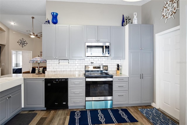 1145 Jaybee Ave, Davenport, FL 33897 - kitchen with appliances with stainless steel finishes, wood finished floors, and backsplash