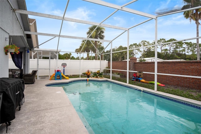 1145 Jaybee Ave, Davenport, FL 33897 - view of swimming pool with a fenced backyard, glass enclosure, and a patio area
