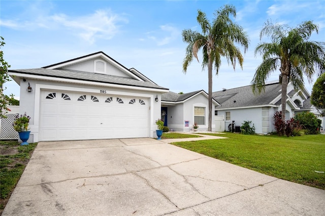 1145 Jaybee Ave, Davenport, FL 33897 - ranch-style home featuring stucco siding, concrete driveway, a front yard, and a garage