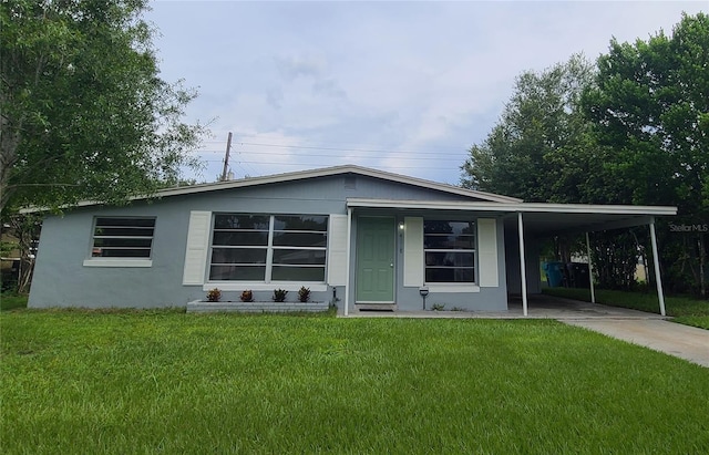 4118 Kirkland Blvd, Orlando, FL 32811 - view of front of property featuring driveway, a front lawn, a carport, and stucco siding