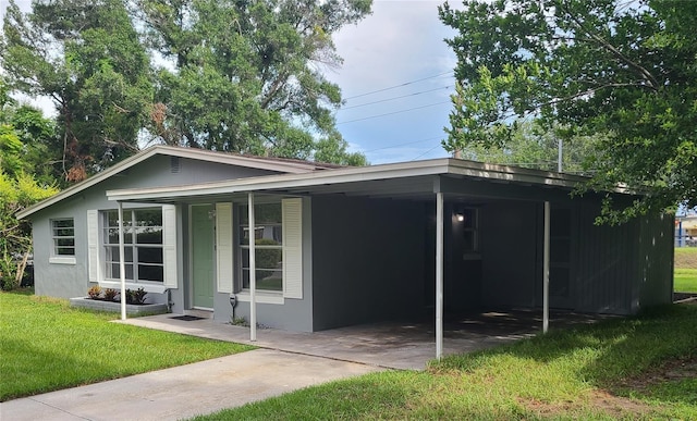 4118 Kirkland Blvd, Orlando, FL 32811 - view of front of house with a front yard, a carport, stucco siding, and concrete driveway