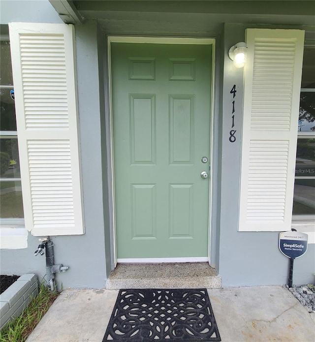 4118 Kirkland Blvd, Orlando, FL 32811 - doorway to property with stucco siding and covered porch