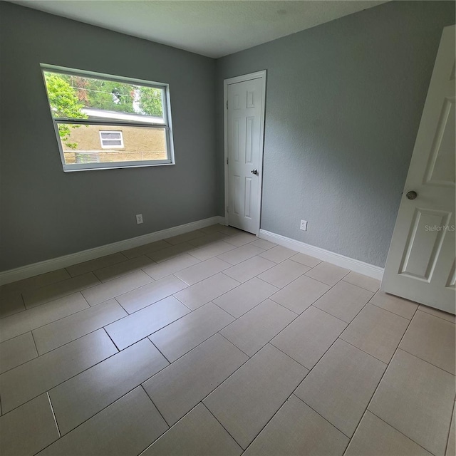 4118 Kirkland Blvd, Orlando, FL 32811 - empty room with baseboards and light tile patterned floors