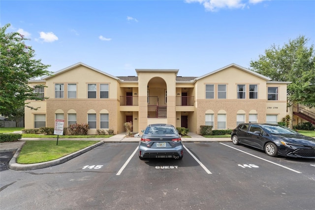 2786 Club Cortile Cir Unit B, Kissimmee, FL 34746 - view of property featuring uncovered parking and stairs