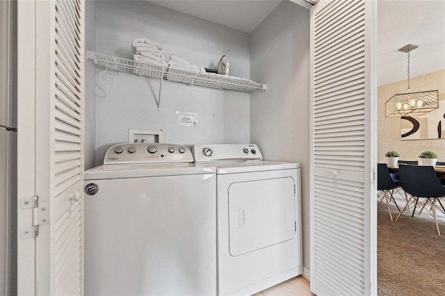 2786 Club Cortile Cir Unit B, Kissimmee, FL 34746 - washroom featuring light colored carpet, washing machine and clothes dryer, and a chandelier