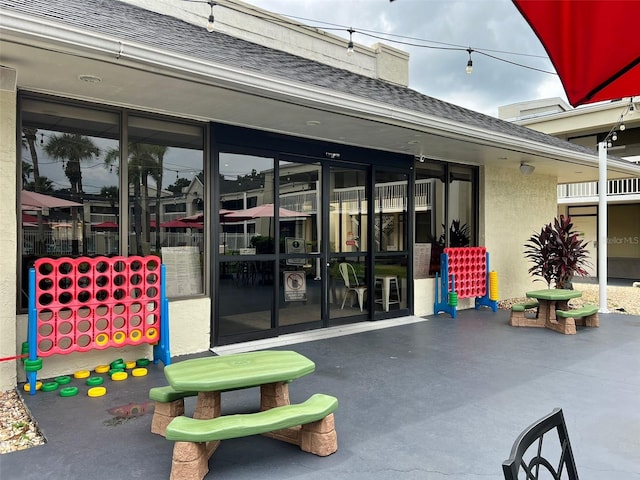 5245 W Irlo Bronson Memorial Hwy Unit 156, Kissimmee, FL 34746 - view of exterior entry with roof with shingles and stucco siding