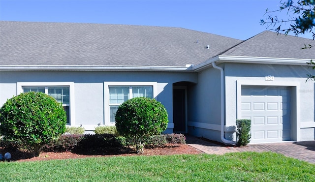 2825 Attwater Loop, Winter Haven, FL 33884 - ranch-style house featuring a garage, a shingled roof, and stucco siding