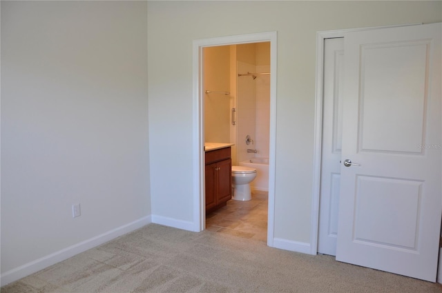 2825 Attwater Loop, Winter Haven, FL 33884 - unfurnished bedroom featuring light colored carpet, ensuite bathroom, and a closet