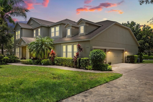 2700 Tree Meadow Loop, Apopka, FL 32712 - traditional home with an attached garage, driveway, stucco siding, and a lawn