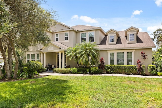 2700 Tree Meadow Loop, Apopka, FL 32712 - view of front facade featuring a front lawn, stucco siding, and roof with shingles
