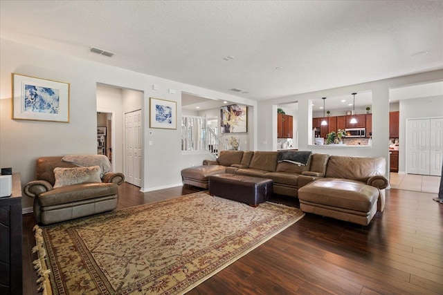 2700 Tree Meadow Loop, Apopka, FL 32712 - living room featuring dark wood-style flooring and a textured ceiling