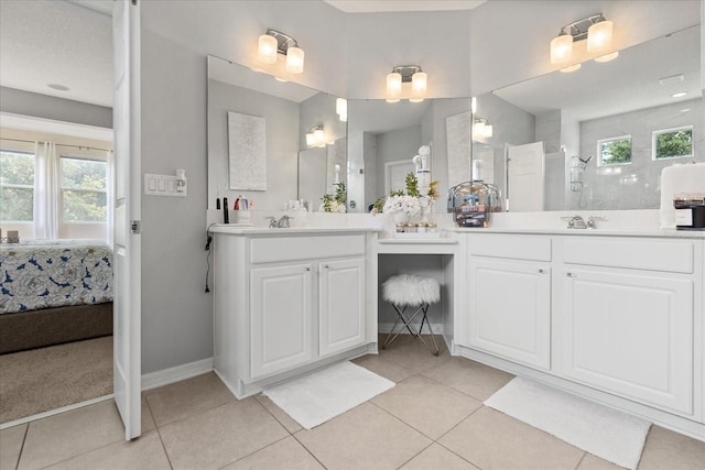 2700 Tree Meadow Loop, Apopka, FL 32712 - ensuite bathroom featuring two vanities, plenty of natural light, and tile patterned flooring