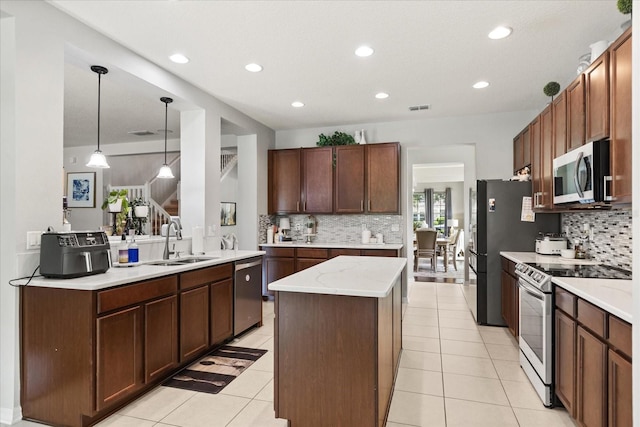 2700 Tree Meadow Loop, Apopka, FL 32712 - kitchen featuring appliances with stainless steel finishes, backsplash, recessed lighting, a center island, and light tile patterned floors