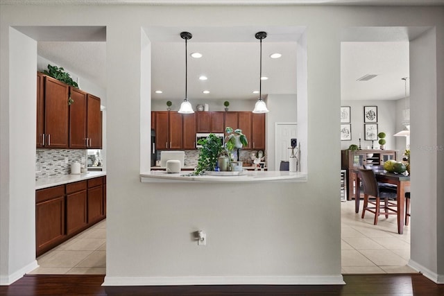 2700 Tree Meadow Loop, Apopka, FL 32712 - kitchen featuring decorative backsplash, light countertops, light tile patterned floors, and recessed lighting