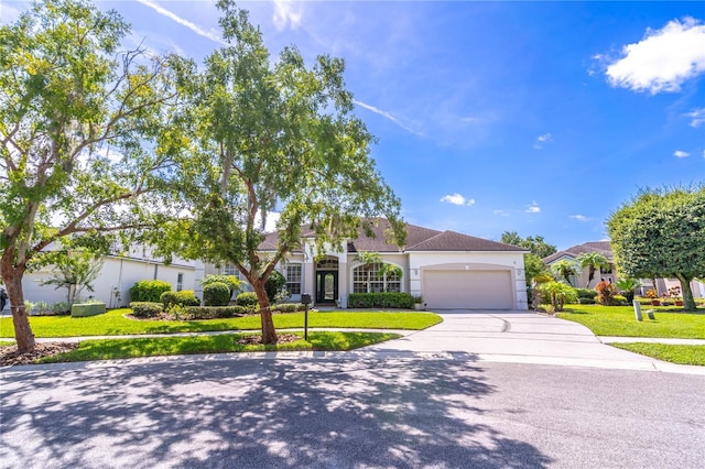 2340 Blackjack Oak St, Ocoee, FL 34761 - view of front facade featuring a garage, driveway, stucco siding, and a front yard
