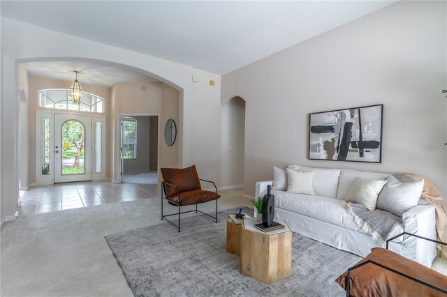 2340 Blackjack Oak St, Ocoee, FL 34761 - carpeted living room featuring arched walkways and tile patterned floors