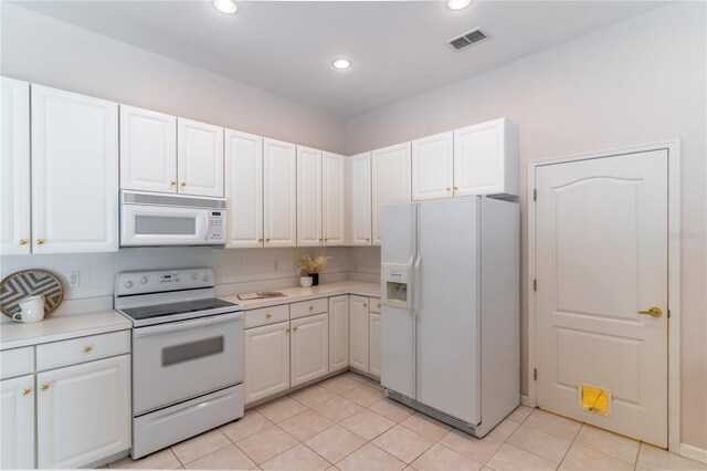 2340 Blackjack Oak St, Ocoee, FL 34761 - kitchen with white appliances, light countertops, white cabinets, light tile patterned floors, and recessed lighting