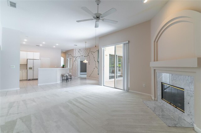 2340 Blackjack Oak St, Ocoee, FL 34761 - unfurnished living room with a fireplace, light colored carpet, ceiling fan, and recessed lighting