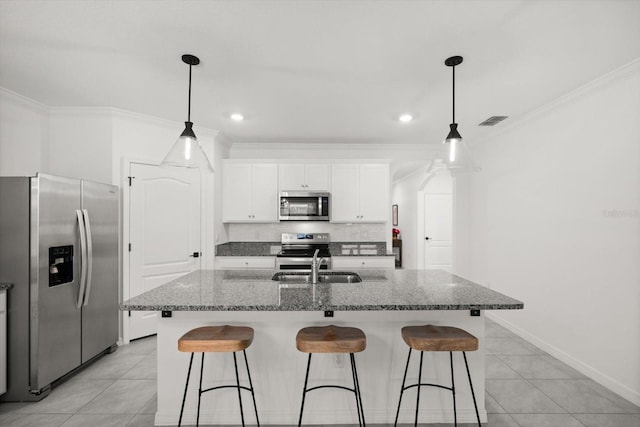 5684 Horseshoe Loop, Apopka, FL 32712 - kitchen featuring stainless steel appliances, light tile patterned flooring, a breakfast bar area, white cabinetry, and ornamental molding