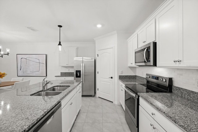 5684 Horseshoe Loop, Apopka, FL 32712 - kitchen featuring appliances with stainless steel finishes, white cabinetry, decorative light fixtures, crown molding, and recessed lighting