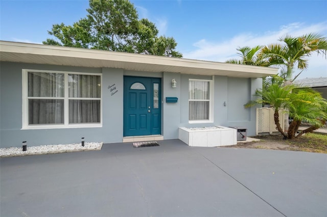 entrance to property with stucco siding