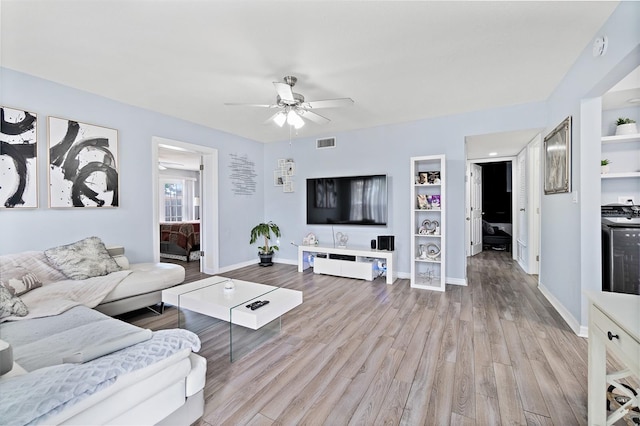 living room featuring ceiling fan and light wood-type flooring